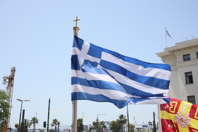 Athens, Greece - May 25, 2022: Beautiful view of Greece flag against blue sky on city street