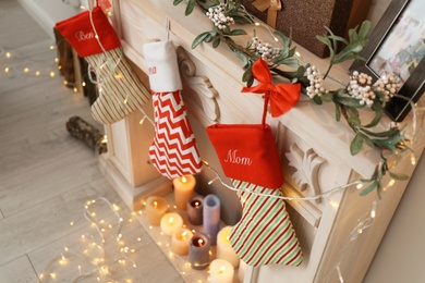 Decorative fireplace with Christmas stockings in living room