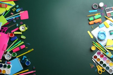 Photo of Different bright school stationery on green background, flat lay. Space for text