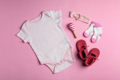 Flat lay composition with cute clothes on color background. Baby accessories