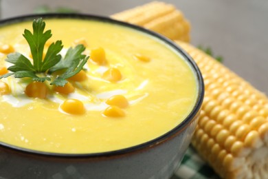 Photo of Delicious creamy corn soup in bowl, closeup