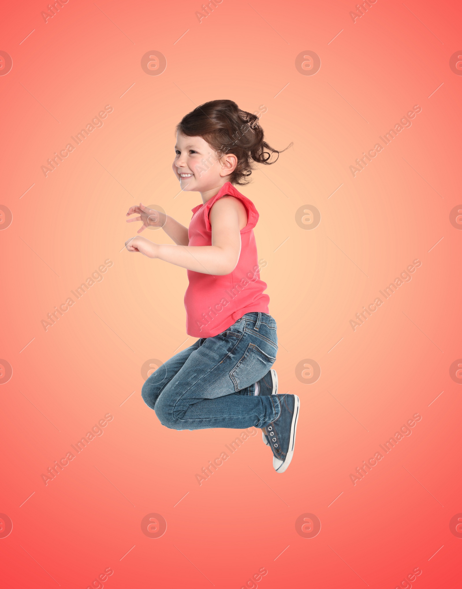 Image of Happy cute girl jumping on color gradient background