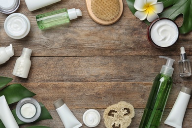 Photo of Flat lay composition with body care products and space for text on wooden background
