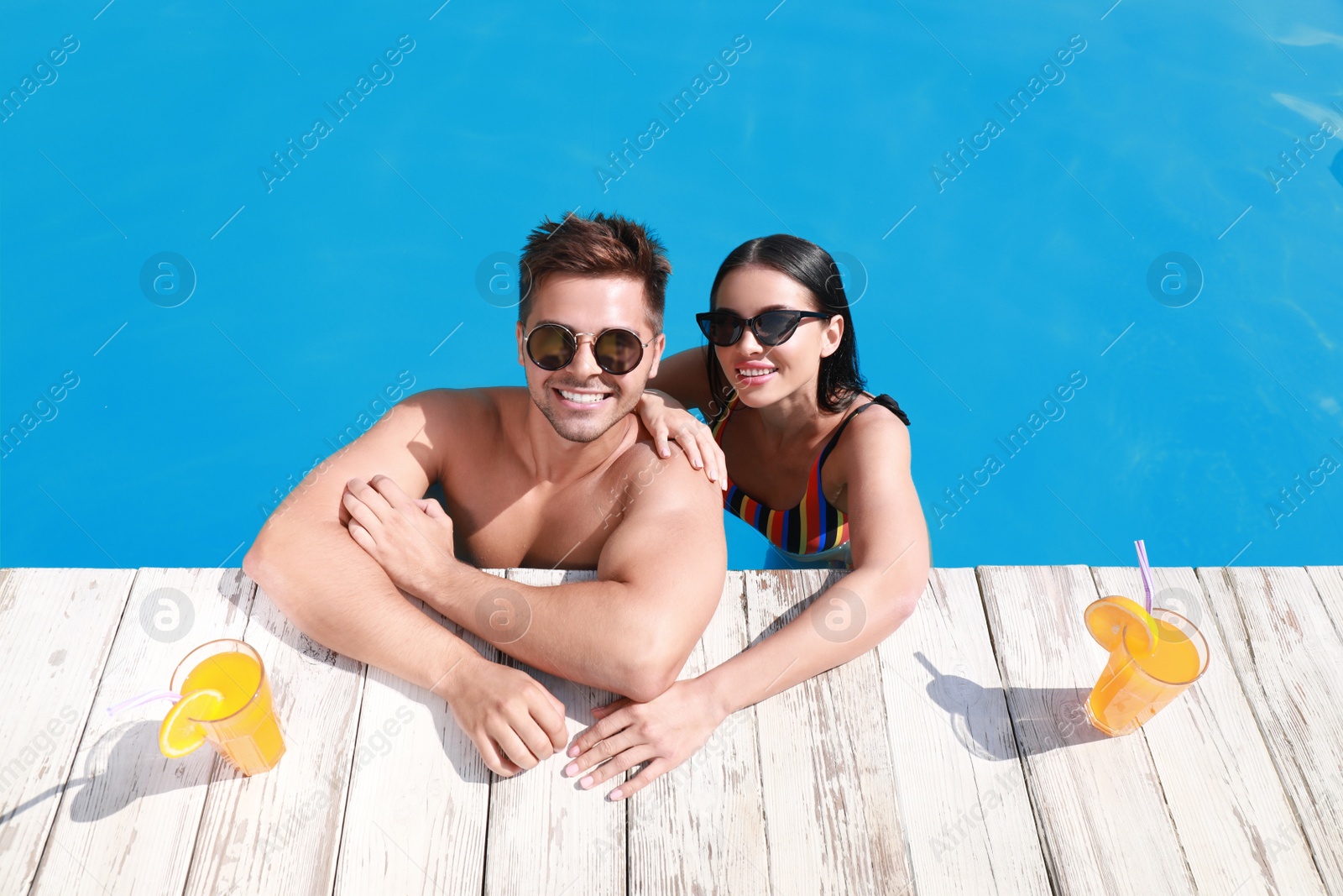 Photo of Woman in bikini with boyfriend at resort. Happy young couple