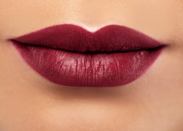 Image of Woman with beautiful perfect lips after permanent makeup procedure, closeup