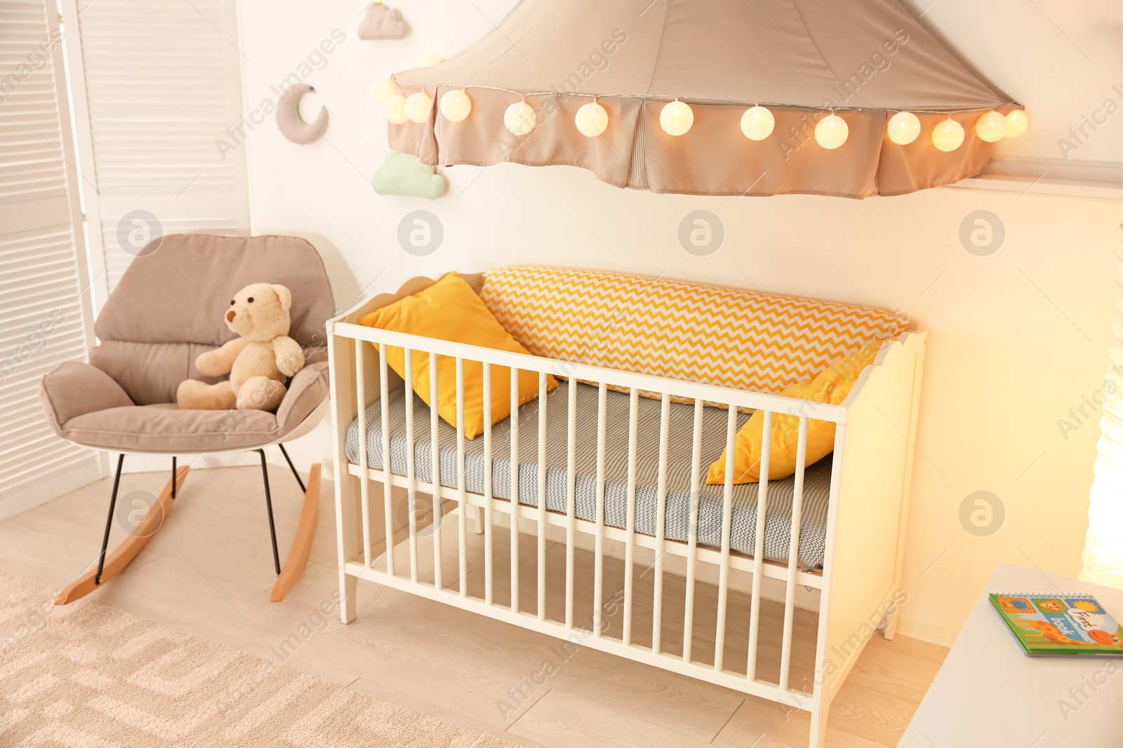 Photo of Stylish baby room interior with crib