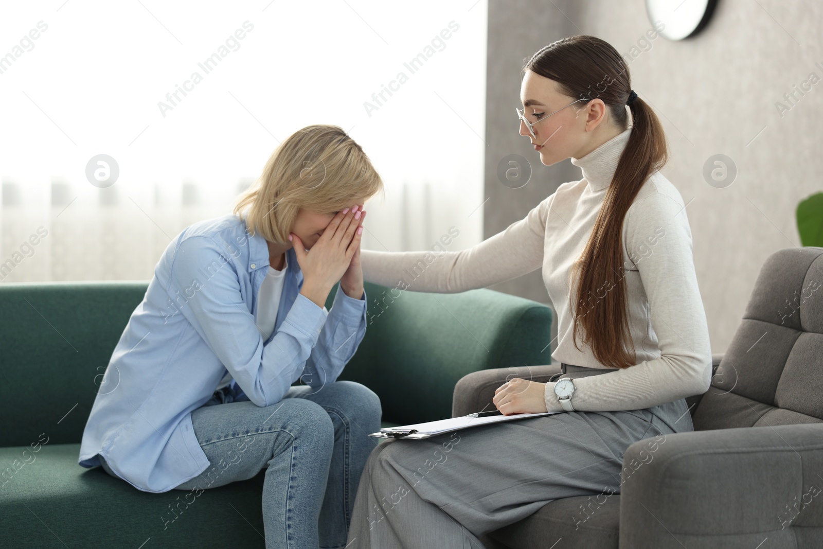 Photo of Professional psychotherapist working with patient in office