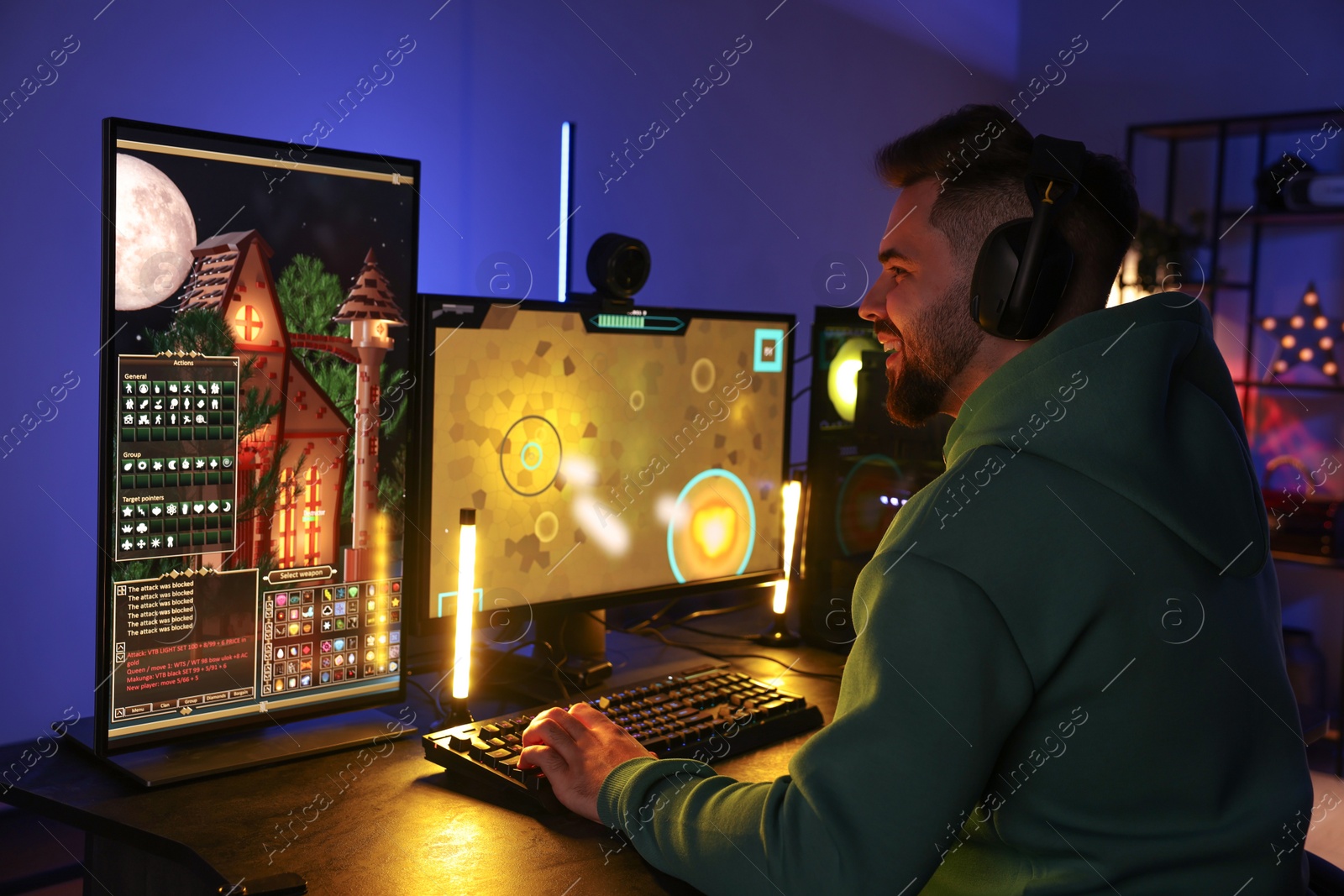 Photo of Man playing video games on computer at table indoors