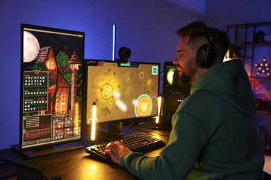 Man playing video games on computer at table indoors