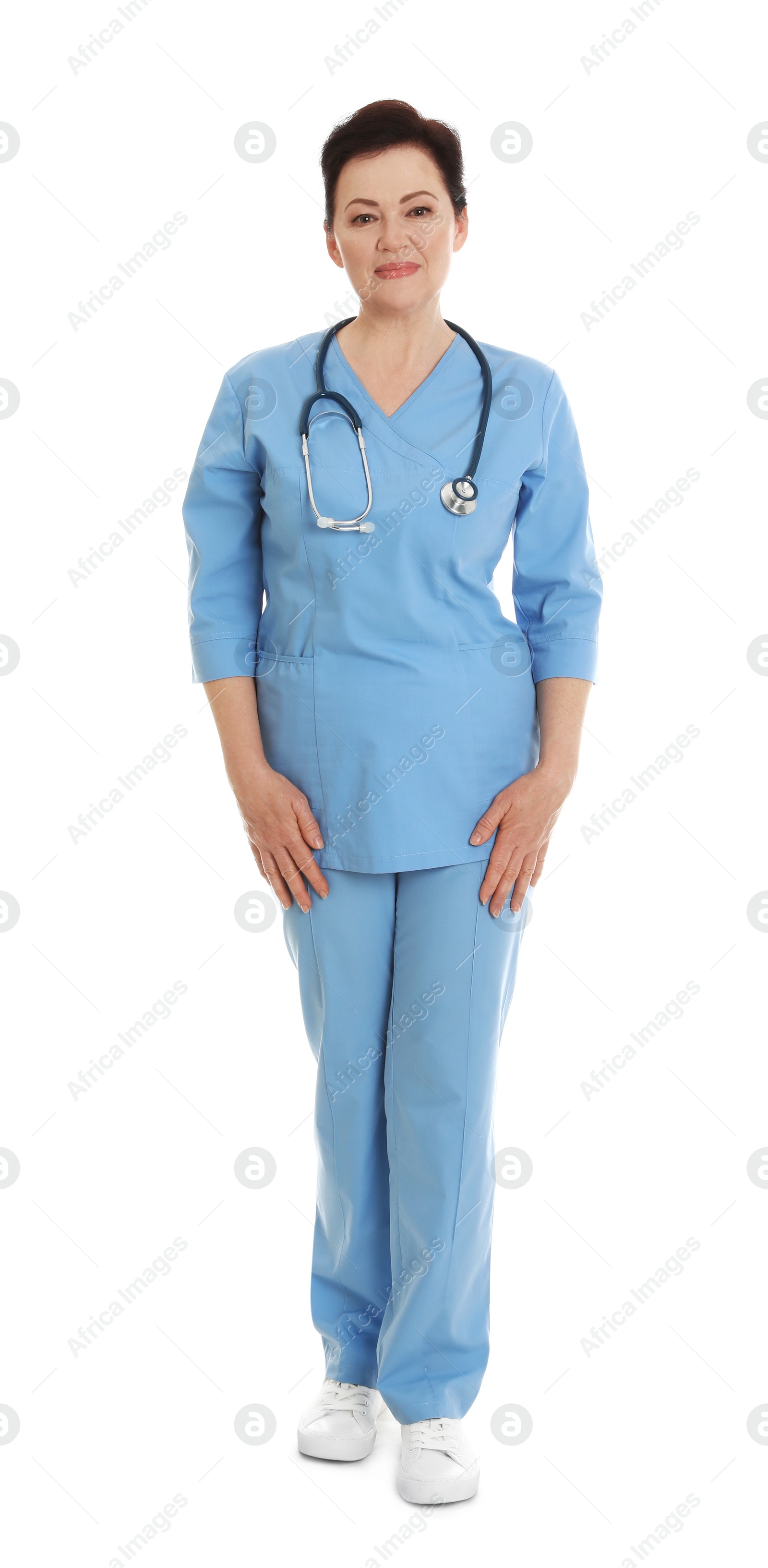 Photo of Full length portrait of female doctor in scrubs isolated on white. Medical staff