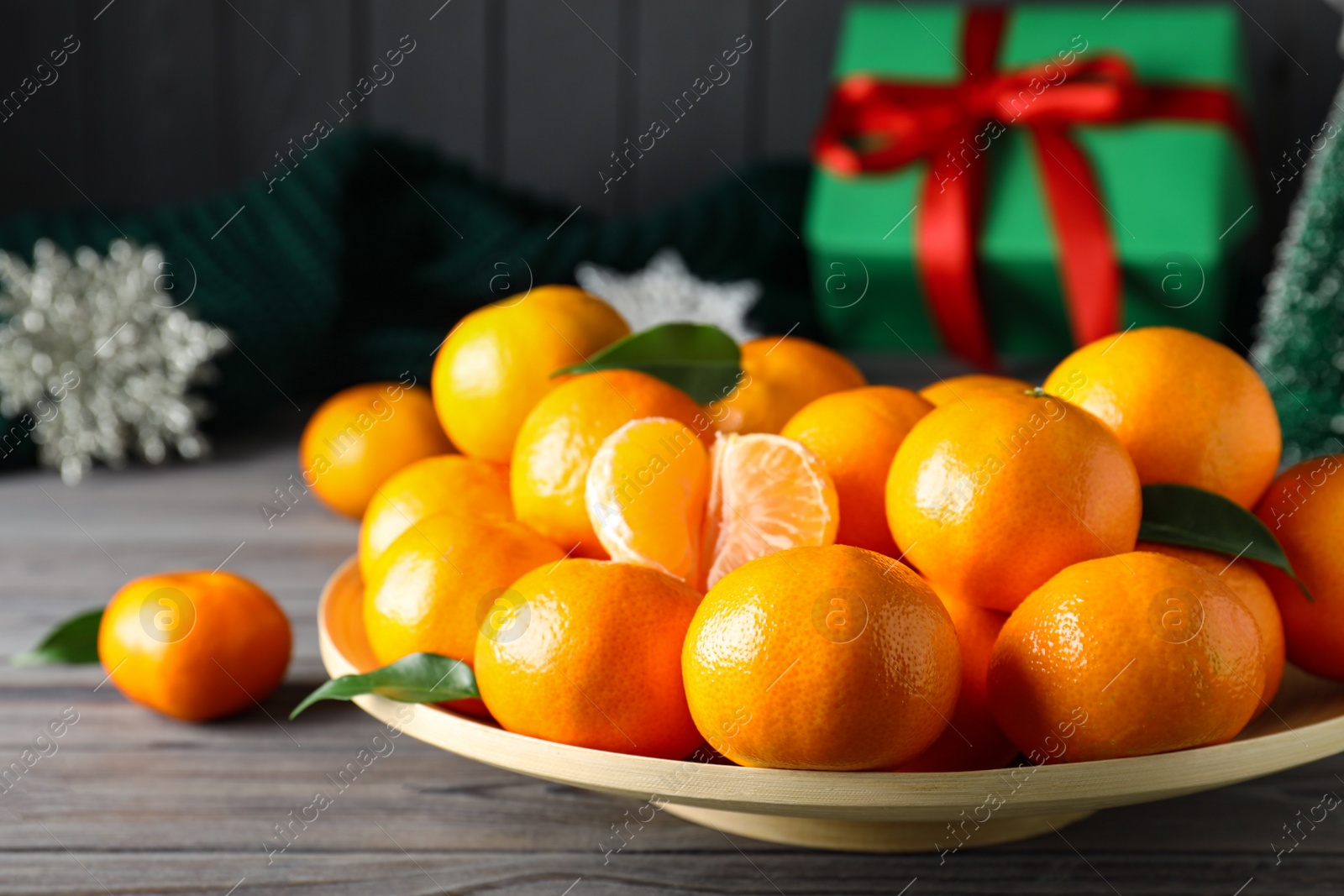 Photo of Tasty fresh tangerines on wooden table. Christmas celebration