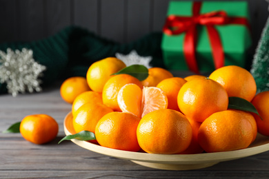 Photo of Tasty fresh tangerines on wooden table. Christmas celebration