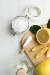 Photo of Baking soda, vinegar and cut lemons on white wooden table, flat lay