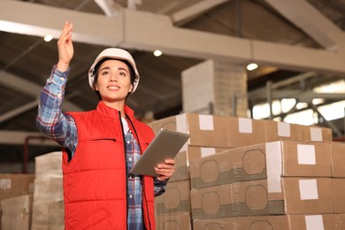 Image of Woman with tablet working at warehouse. Logistics center