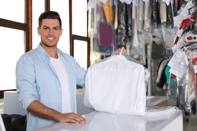 Photo of Happy client with shirt at modern dry-cleaner's