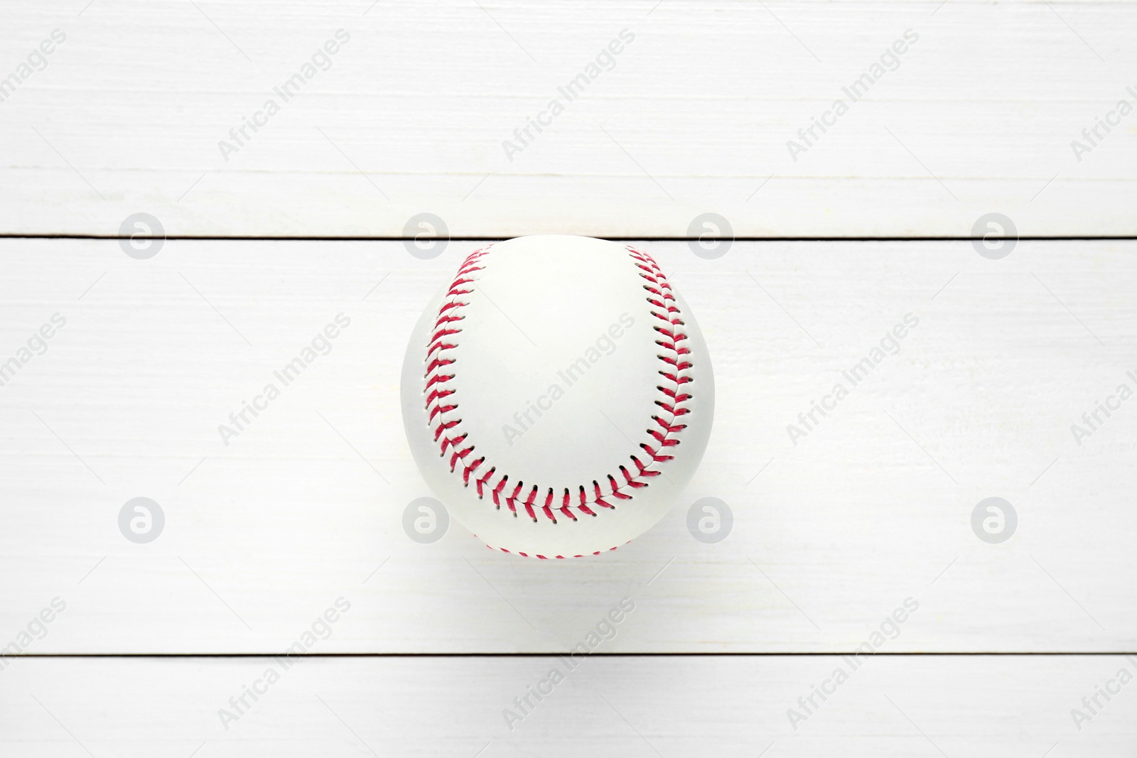 Photo of Baseball ball on white wooden table, top view. Sports game