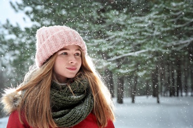 Portrait of teenage girl in winter snowy forest