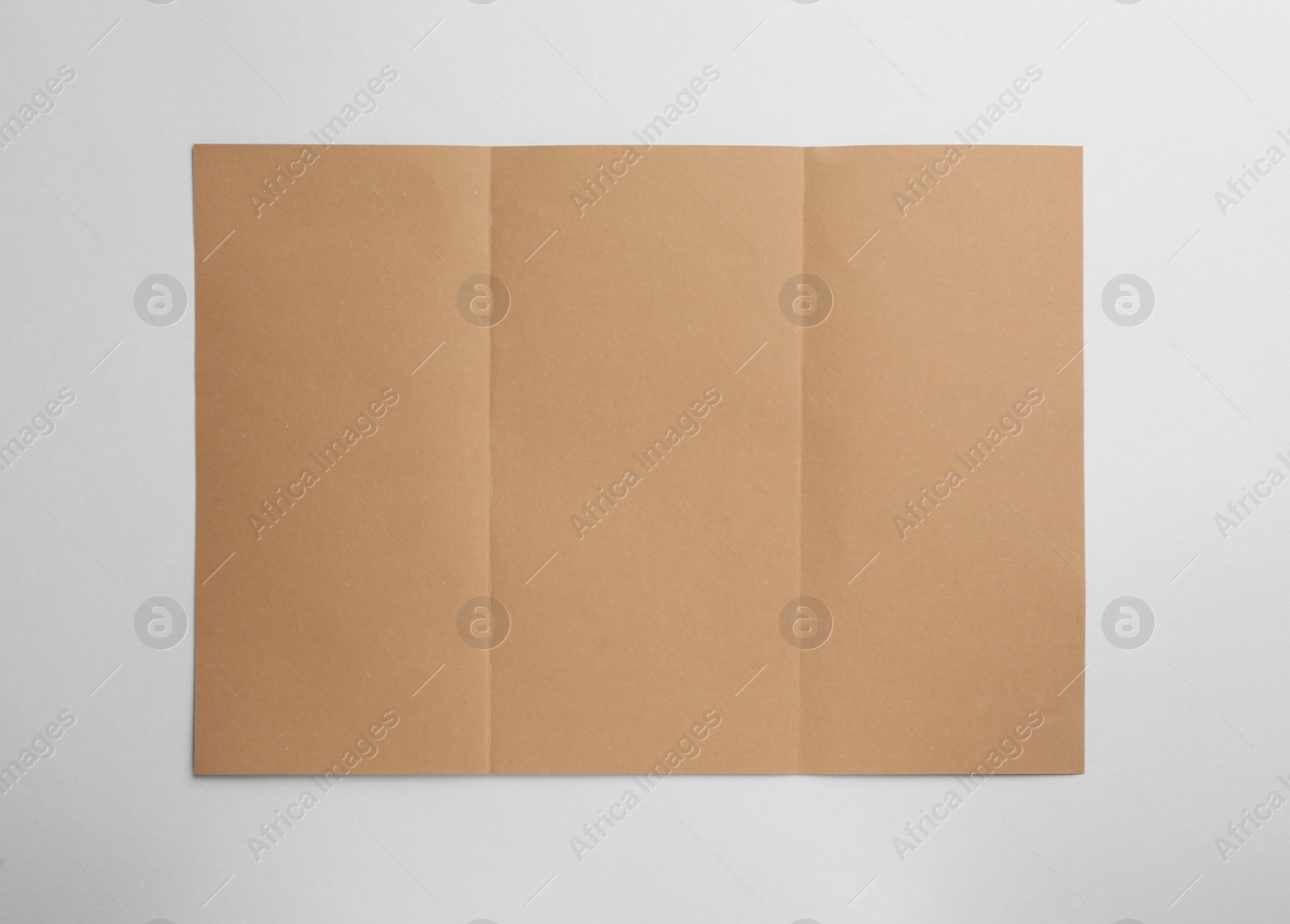 Photo of Sheet of brown paper on white background, top view