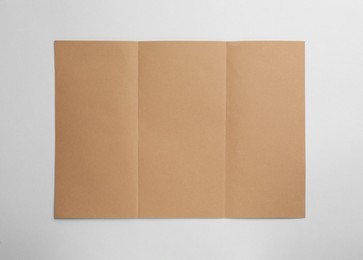 Photo of Sheet of brown paper on white background, top view