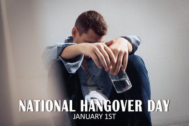 Image of National hangover day - January 1st. Man with bottle of alcohol near wall