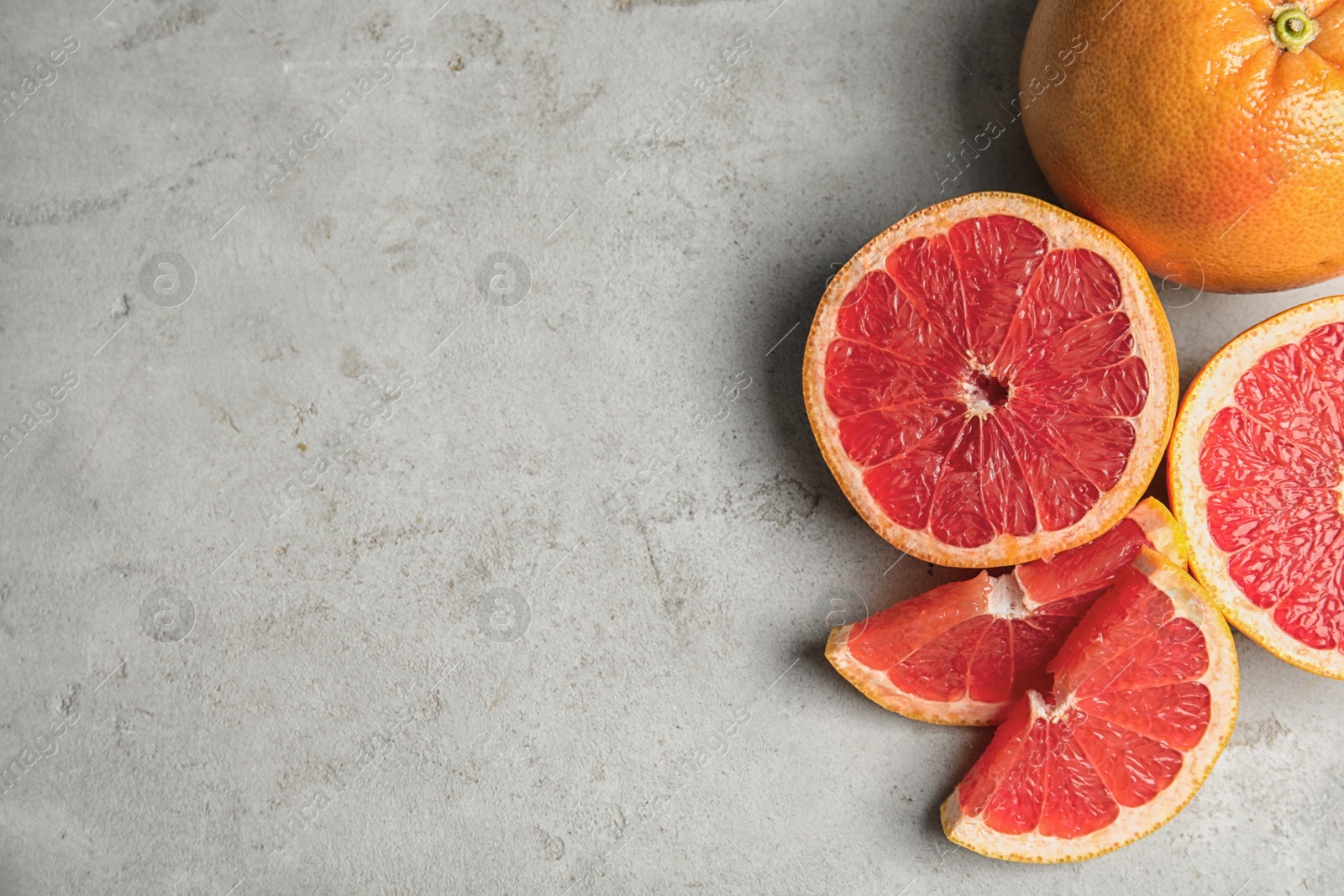 Photo of Fresh tasty grapefruits on table, top view with space for text