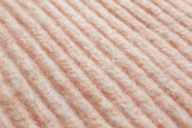 Photo of Beautiful pale pink knitted fabric as background, closeup