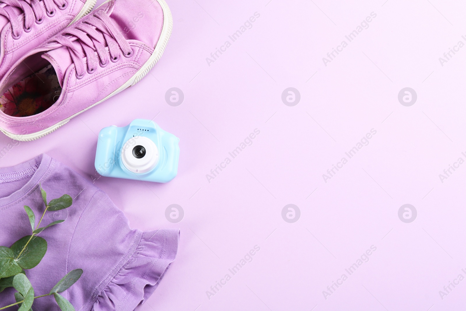 Photo of Flat lay composition with little photographer's toy camera on pink background. Space for text