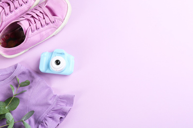 Flat lay composition with little photographer's toy camera on pink background. Space for text