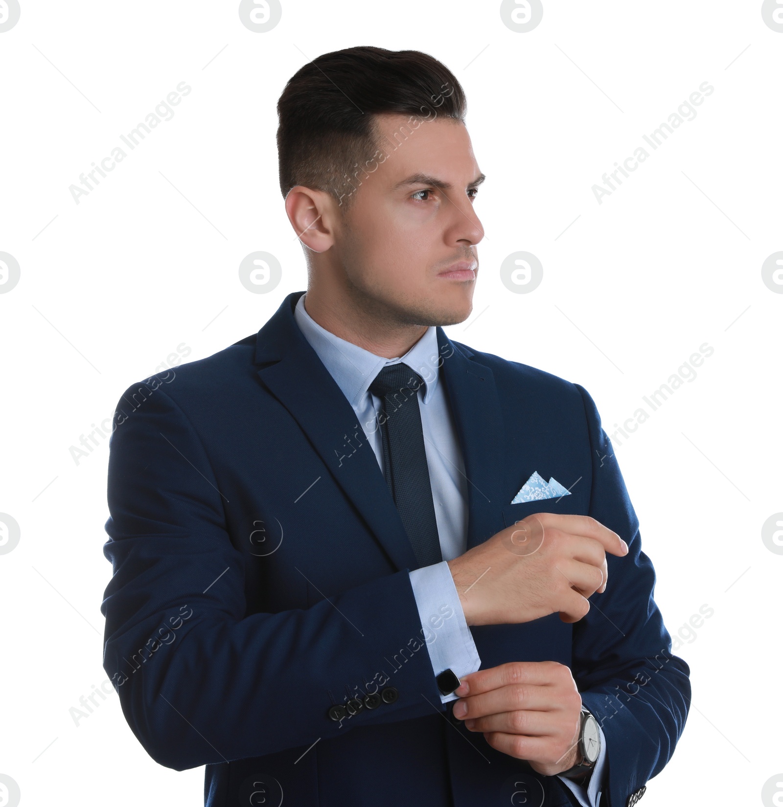 Photo of Handsome stylish man putting on cufflink against white background