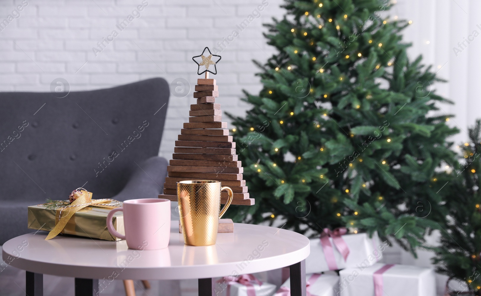 Photo of Different cups and beautiful Christmas decor on table indoors. Interior design