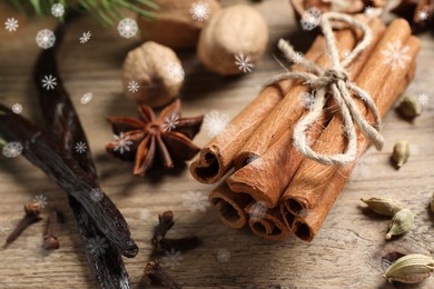 Image of Different spices on wooden table, closeup. Cinnamon, cloves, anise, cardamom, vanilla, nutmegs