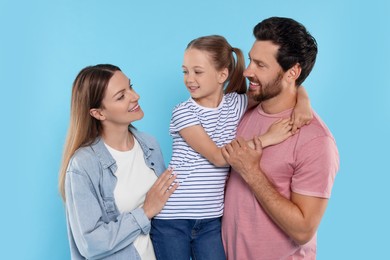 Happy family together on light blue background