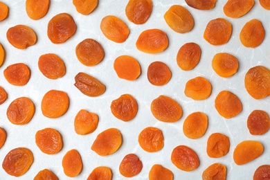 Photo of Flat lay composition with apricots on grey background. Dried fruit as healthy food