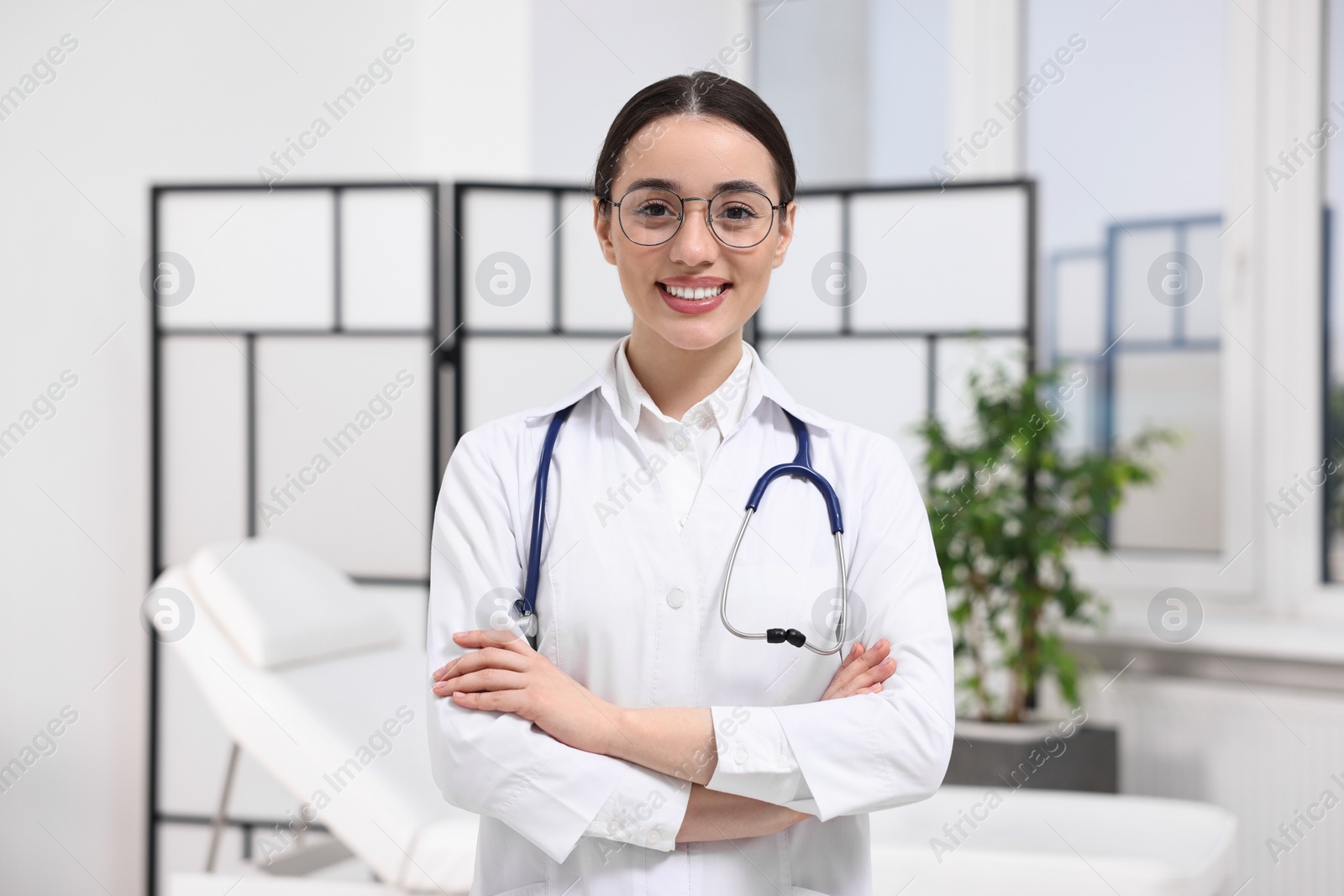 Photo of Medical consultant with glasses and stethoscope in clinic