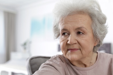 Photo of Portrait of mature woman in living room