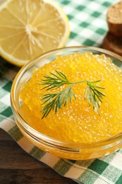 Photo of Fresh pike caviar in bowl on wooden table, closeup