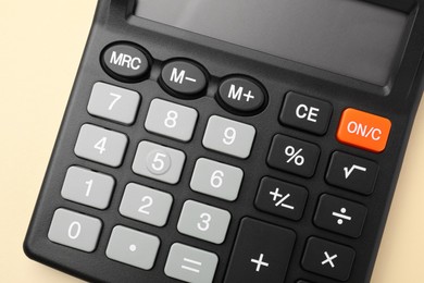 Calculator on beige background, top view. Office equipment