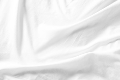 Photo of Crumpled white fabric as background, top view