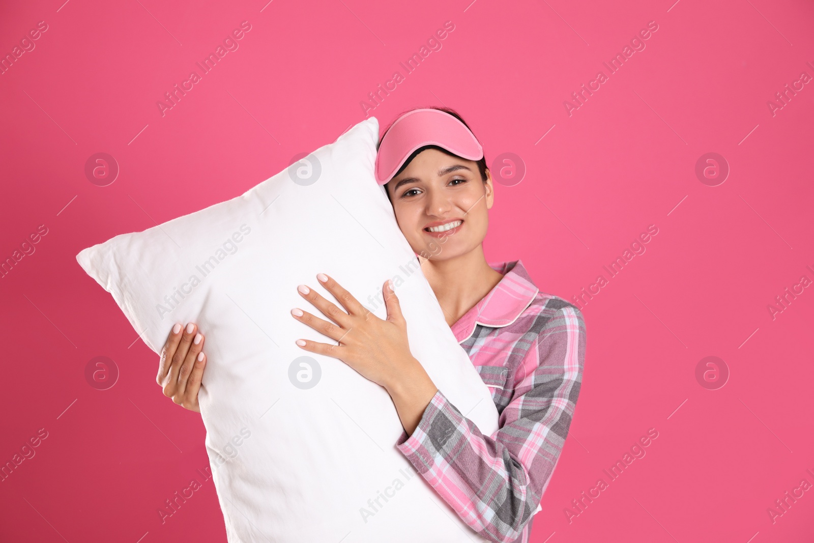 Photo of Beautiful woman with pillow on pink background. Bedtime