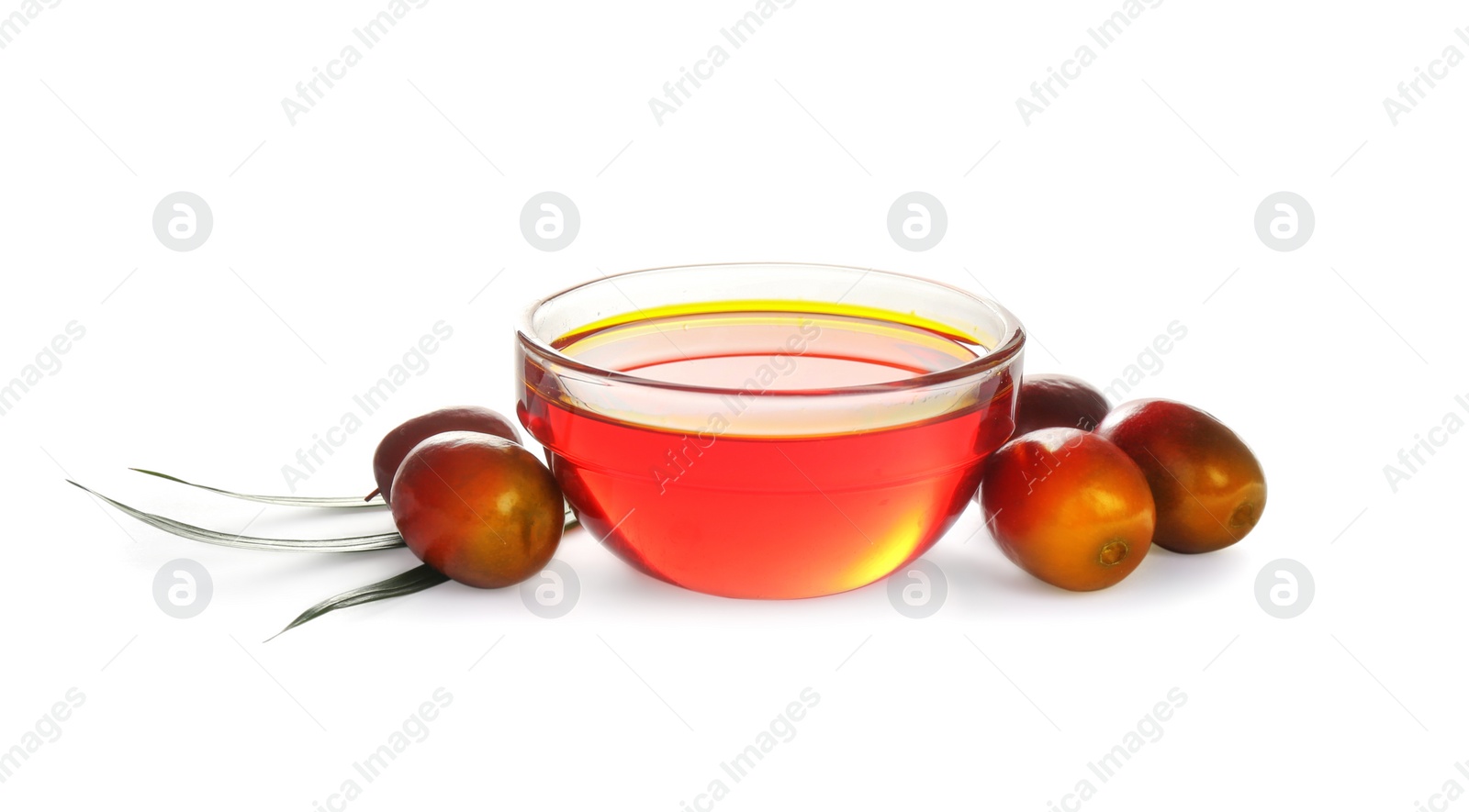 Photo of Palm oil in glass bowl, tropical leaf and fruits isolated on white