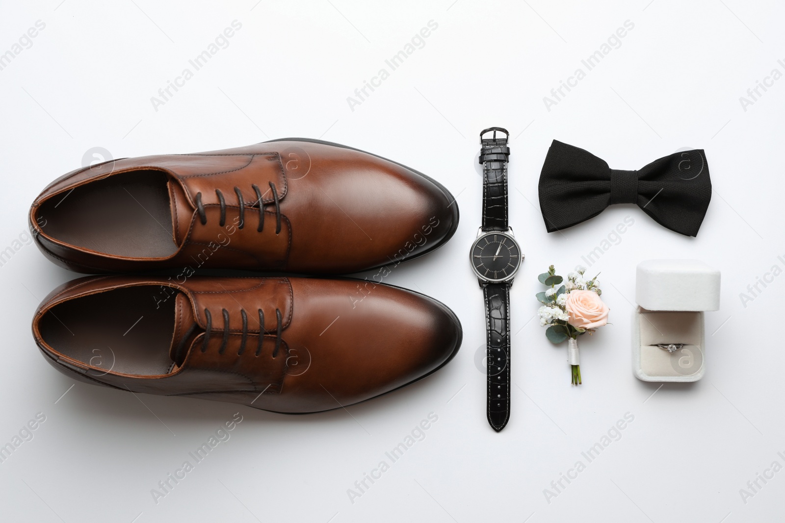 Photo of Composition with wedding shoes for groom on white background, top view