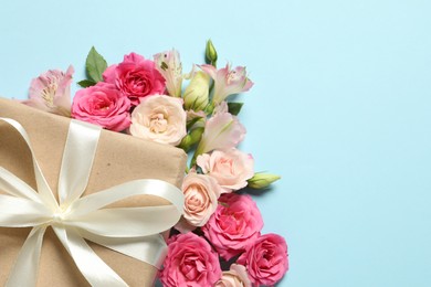 Photo of Happy Mother's Day. Beautiful flowers and gift box on light blue background, flat lay. Space for text