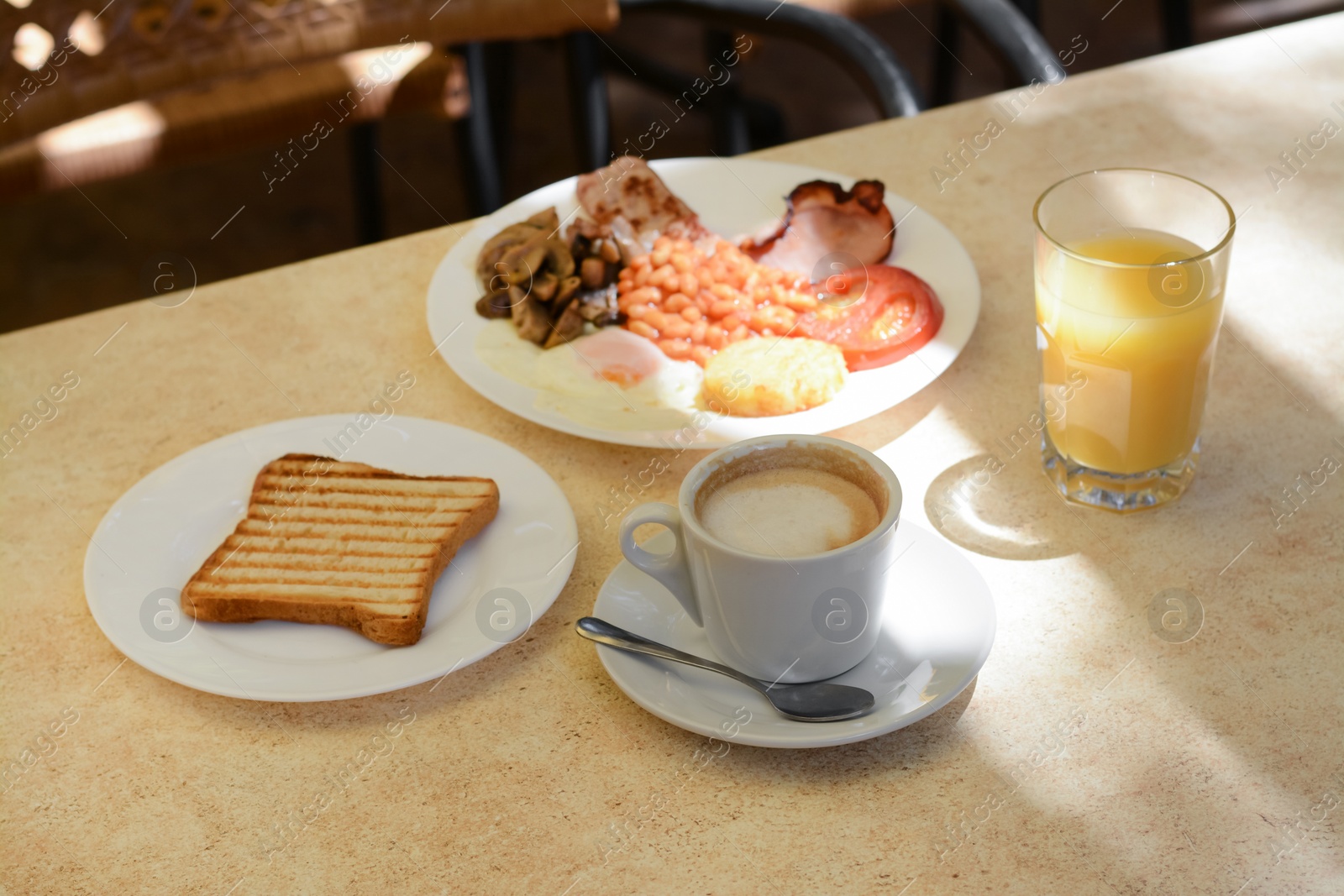 Photo of Delicious breakfast with fried meat and vegetables served on beige table