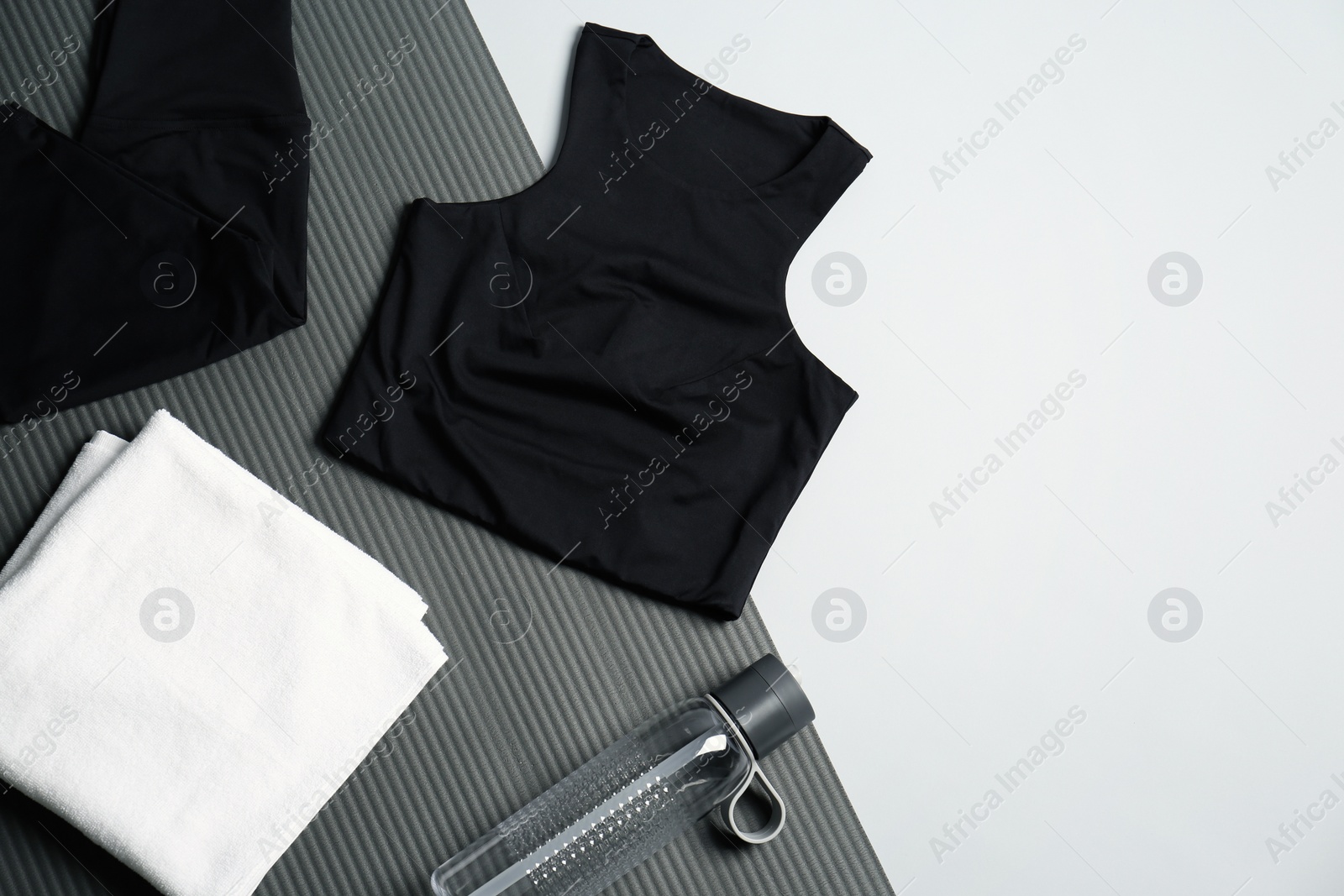 Photo of Flat lay composition with yoga equipment on grey background. Space for text