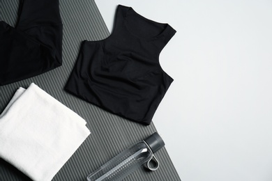 Flat lay composition with yoga equipment on grey background. Space for text