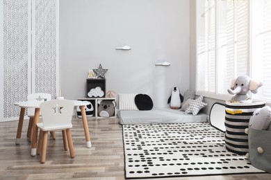 Photo of Montessori bedroom interior with floor bed and toys