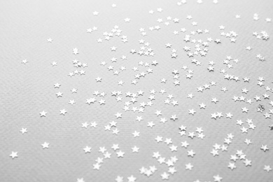 Photo of Confetti stars on grey background. Christmas celebration