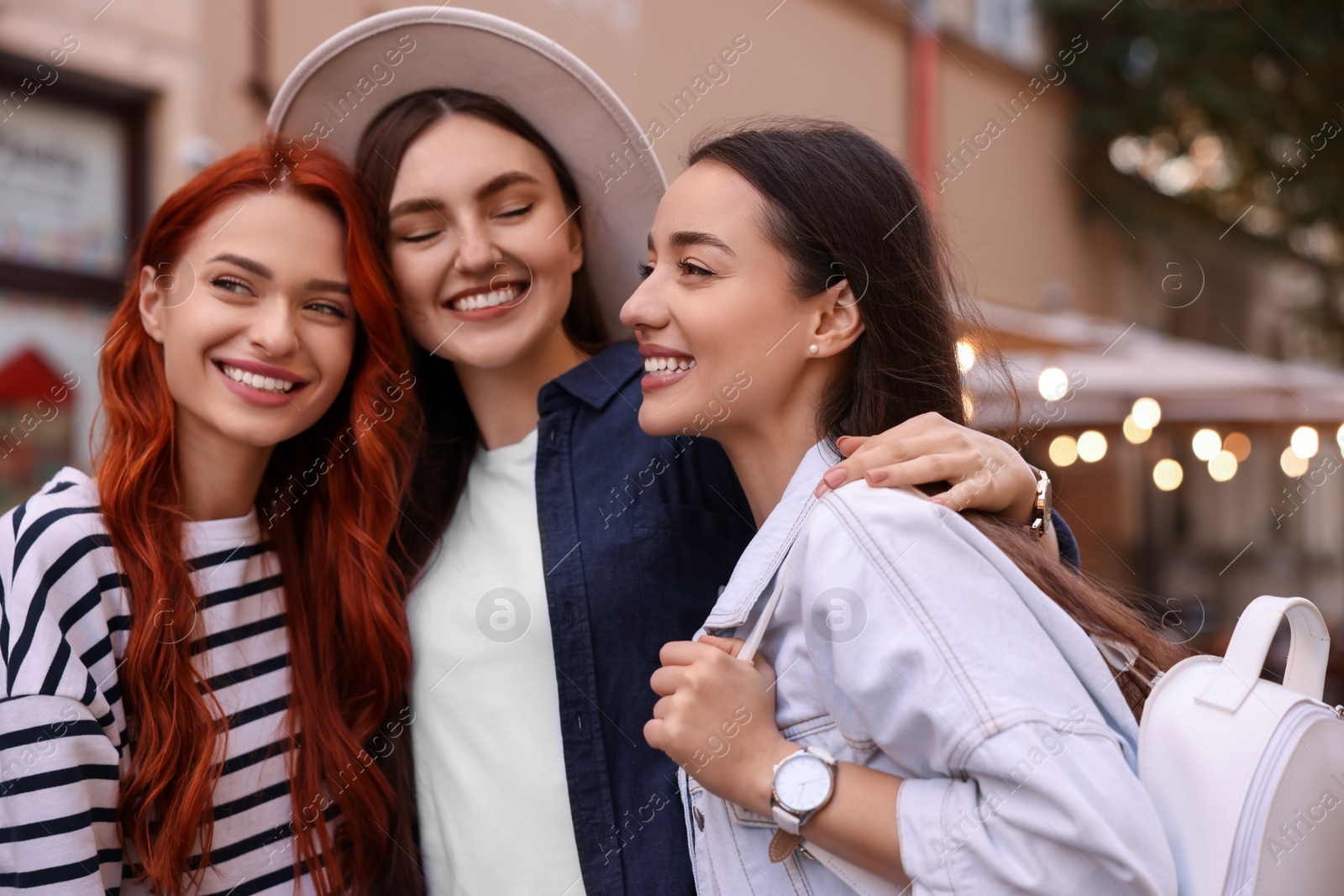 Photo of Happy friends spending time together on city street