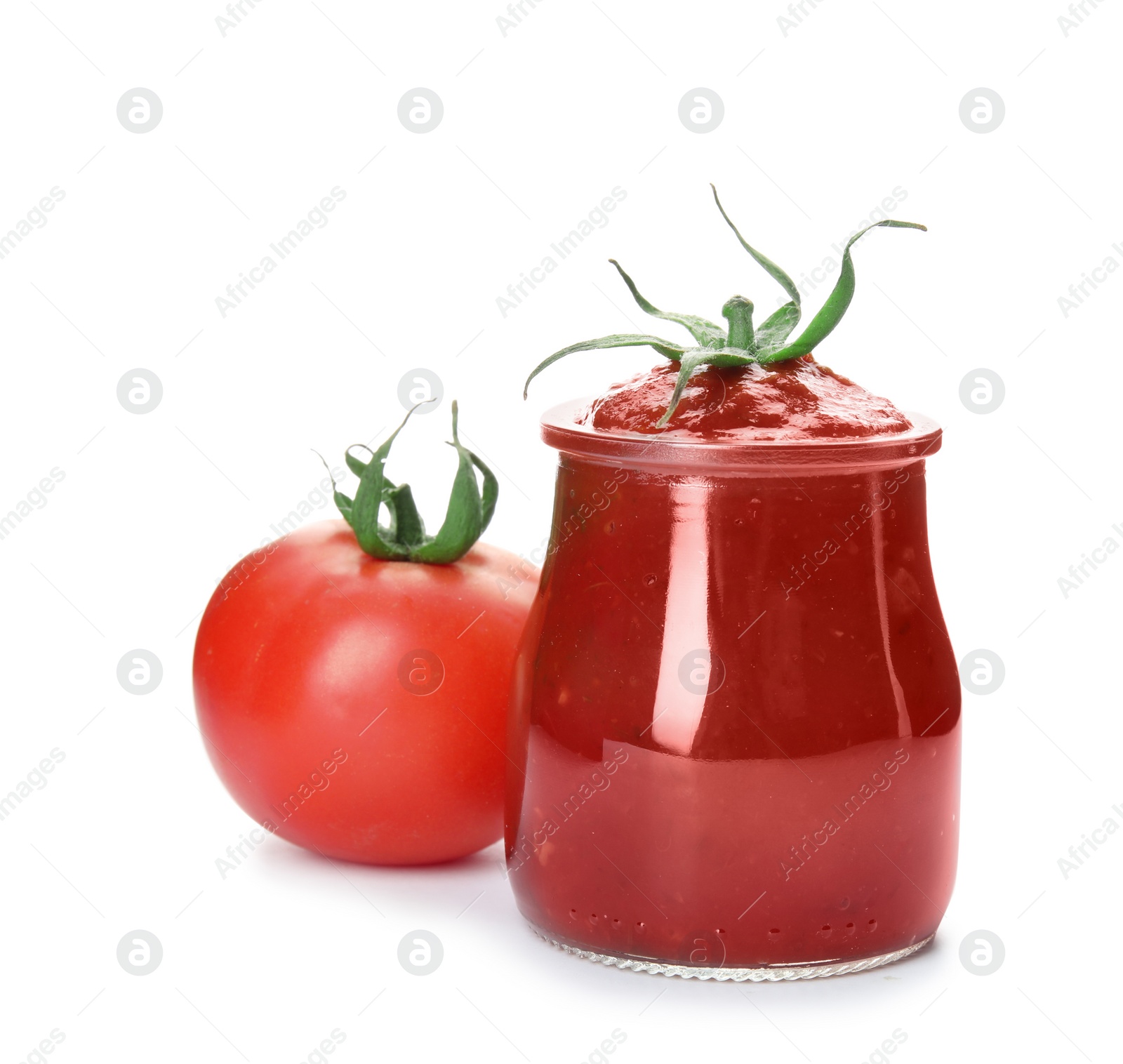 Photo of Tasty homemade tomato sauce in glass jar and fresh vegetable on white background