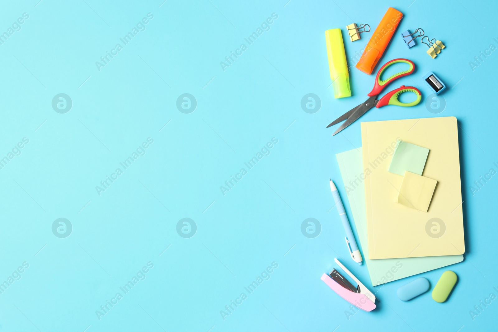 Photo of Flat lay composition with different school stationery on light blue background, space for text. Back to school